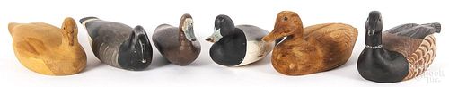 Four carved and painted duck decoys, together with