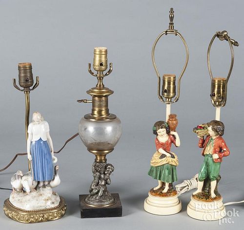 Four figural table lamps.