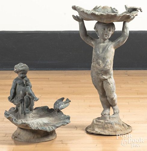 Two lead putti bird baths, 15" h. and 27" h.