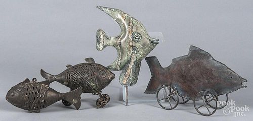 Four modern metal fish figures.