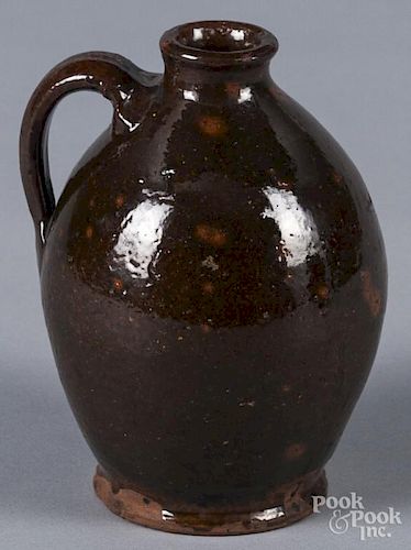 Small New England redware jug, 19th c., with orang