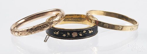 Cartier style bangle bracelet, marked 750, 2 1/4'' h., 2 5/8'' w., 13. g., together with a gold fill