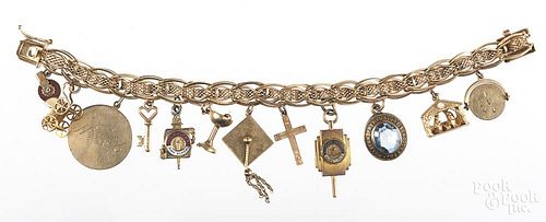 14K yellow gold charm bracelet, with assorted charms, 48.2 g.