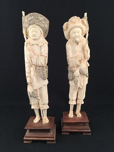 CIrca 1880 pair of carved  fishers, each figure with a pole and a catch of fish.