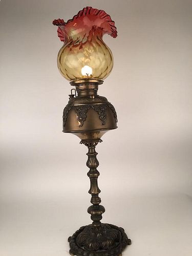 Antique parlor lamp with a cranberry glass scalloped shade.<BR>Converted from gas