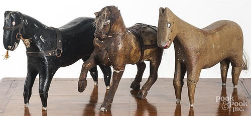Two folk art carved and painted horses, 10 1/2'' h., together with a carved and gessoed horse, 10 3/4