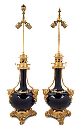 A Pair of Gilt Bronze Mounted Sevres Style Porcelain Oil Lamps Height 31 inches overall.