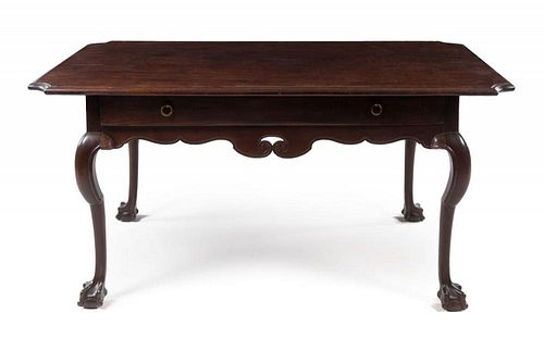 A Spanish Colonial Mahogany Side Table Height 31 1/2 x width 65 x depth 39 inches.