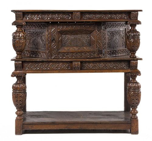 A Jacobean Style Carved Oak Court Cupboard Height 51 3/8 x width 53 5/8 x depth 22 inches.
