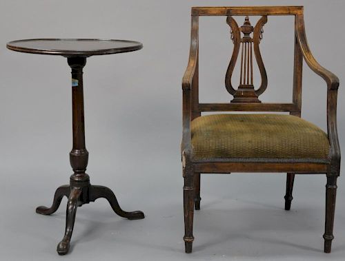 Two piece lot including a round mahogany candlestand (ht. 28in., dia. 19 1/2in.) and a Continental armchair, both 19th centur