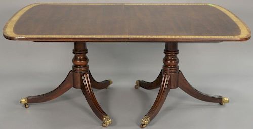 Henredon mahogany double pedestal dining table with banded inlaid top plus two 22 inch leaves and custom pads. ht. 29in., top