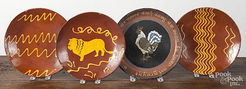 Three Breininger redware chargers, together with a Hay Creek charger, 10 1/4'' dia.