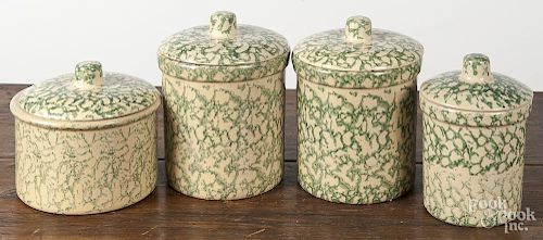 Four green spongeware lidded canisters, tallest - 8''.