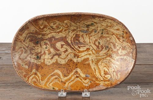 Redware loaf dish, 19th c., with mottled yellow slip decoration, 7 1/2'' h., 12'' w.