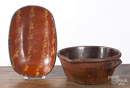 Pennsylvania redware loaf dish, 19th c., with yellow slip decoration, together with a large redware