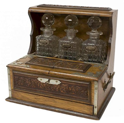 ARTS & CRAFTS OAK TANTALUS WITH THREE DECANTERS