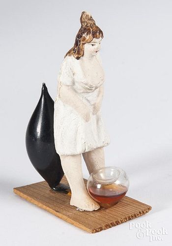 German composition woman urinating barometer toy, early 20th c., with box, 3 1/2" h.