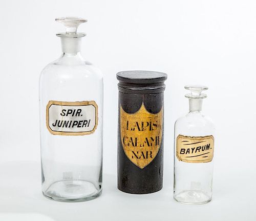 TWO GLASS APOTHECARY JARS AND STOPPERS, AND A BLACK PAINTED WOOD JAR WITH LID