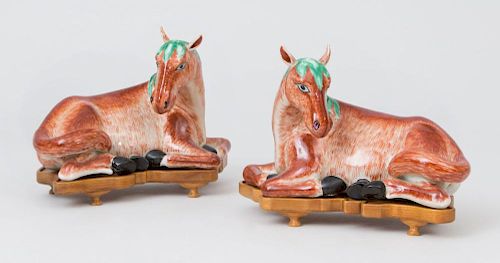 PAIR OF CHINESE EXPORT STYLE IRON RED RECUMBENT HORSES