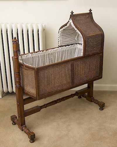 LATE REGENCY MAHOGANY AND CANED CHILD'S CRADLE
