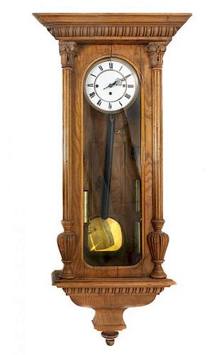 An Oak Wall Clock Height 44 inches.