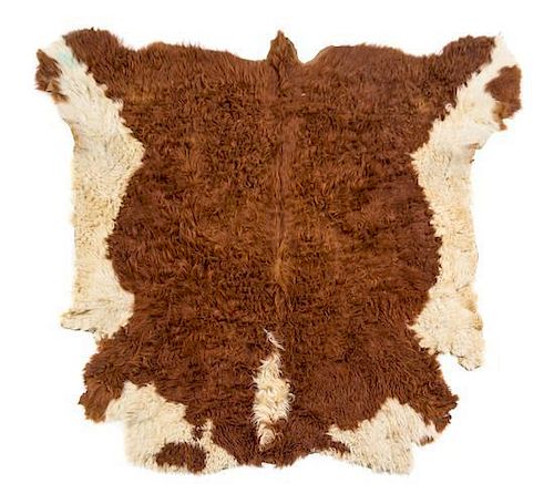 A Cow Hide Rug. Length approximately 78 inches.