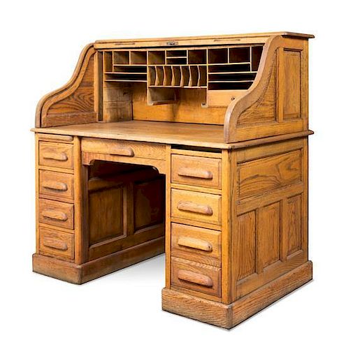 An American Oak Roll Top Desk Height 48 1/2 x width 50 x depth 31 1/2 inches.