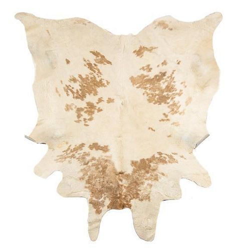 A Cow Hide Rug Approximate Length 105 inches.