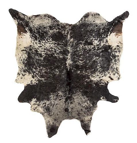 A Cow Hide Rug Length approximately 80 x width 75 inches.