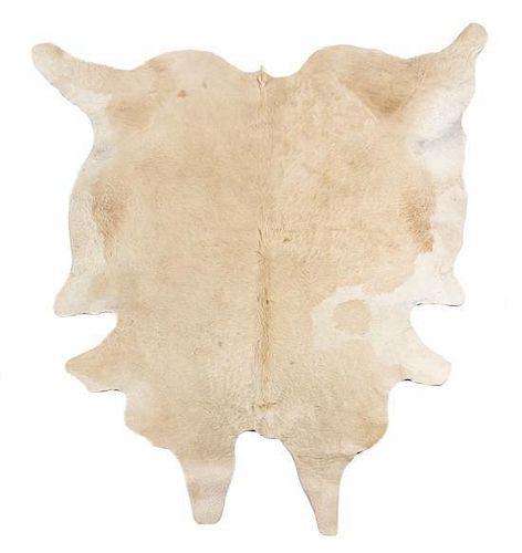 A Cow Hide Rug Length approximately 105 x width 74 inches.