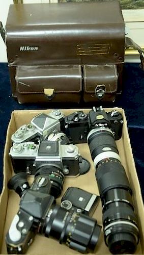 One box lot: Nikon manual focus B lot including Nikon with waist level finder and Vivitar 28/2.8, Nikomat black with Soligor 