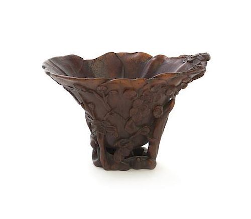A Carved Rhinoceros Horn Libation Cup, Height 3 x width 4 1/2 x depth 3 1/2 inches; 86 grams.