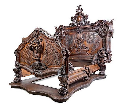 A Baroque Revival Carved Oak and Walnut Bed, Height of headboard 97 1/2 inches.