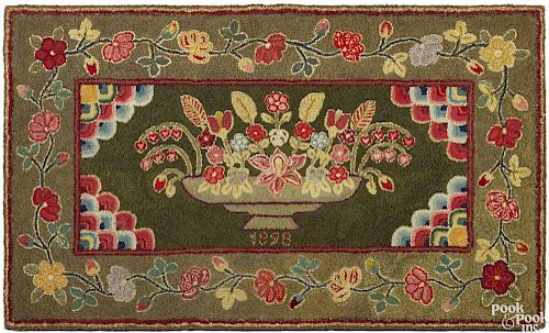 American hooked rug, dated 1898, of a compote of flowers, 34'' x 58''.