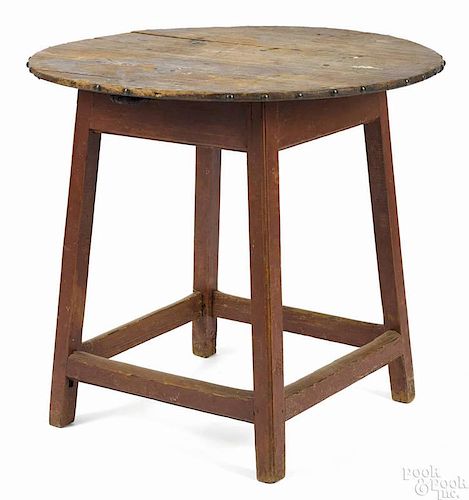 Painted pine and maple tavern table, ca. 1800, having a scrub top with a base retaining an old red