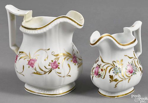 Two Philadelphia Tucker porcelain pitchers, ca. 1825, both with floral and gilt vine decoration, t