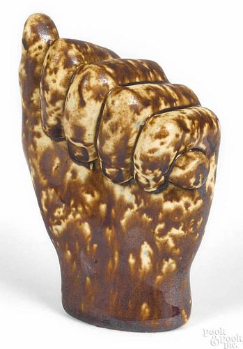 Rockingham glaze pottery clenched fist, 19th c., 4'' h.