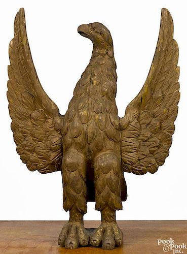 Carved and painted spread winged eagle, 19th c., retaining an old weathered surface with gold pain