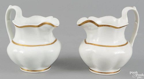 Pair of Tucker porcelain pitchers, ca. 1825, with gilt highlights, 6'' h.