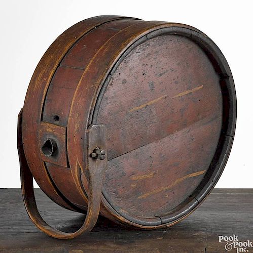 Painted bentwood canteen, 19th c., with a swing handle, retaining its original red surface, 10 3/4