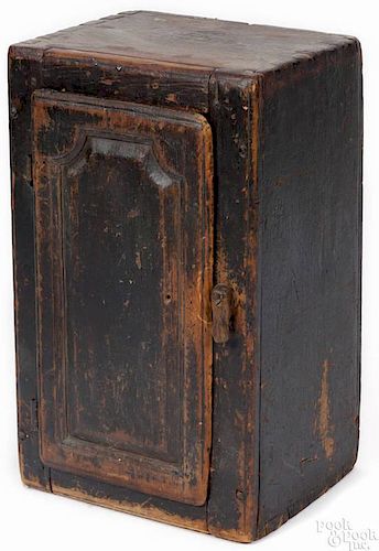 Pennsylvania painted pine hanging cupboard, 19th c., retaining an old black surface, 23 1/2'' h., 1