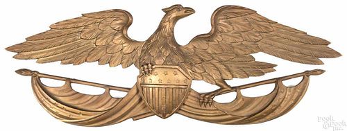 Carved and painted eagle wall plaque, early/mid 20th c., with an American flag and shield, 9'' x 25