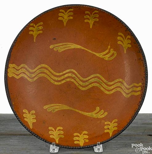 Pennsylvania redware charger, 19th c., with yellow slip decoration, 13 5/8'' dia.