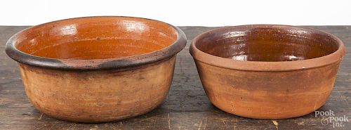 Two Pennsylvania redware bowls, 19th c., 3 3/4'' h., 9 1/2'' dia. and 3 1/2'' h., 8 1/4'' dia.