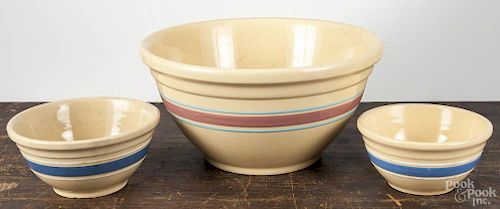 Four yellowware mixing bowls, largest - 8 1/4'' h., 15 3/4'' dia.