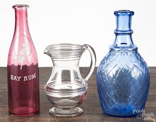 Three pieces of glass, to include Bay Rum bottle, 9'' h., a contemporary cobalt diamond pattern decan