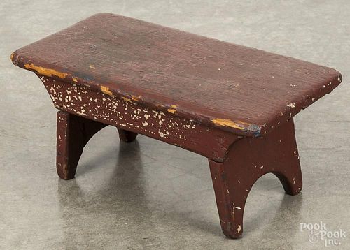 Pennsylvania painted pine foot stool, 19th c., retaining an old red surface, 6 1/2'' h., 14 1/2'' w.