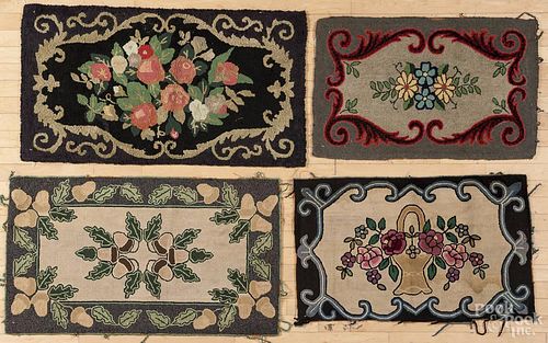Four floral hooked rugs, 20th c., largest - 24'' x 40''.