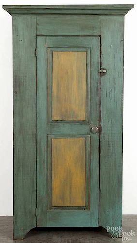 Contemporary painted pine cupboard, having raised panels, retaining a green and yellow surface, 73 1