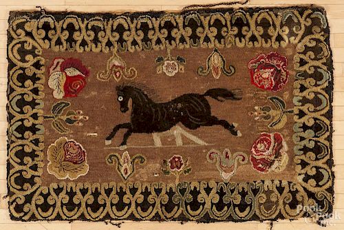Hooked rug with a jumping horse, early 20th c., and a floral background, 58'' x 37''.